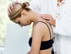 Doctor checks neck for osteochondrosis